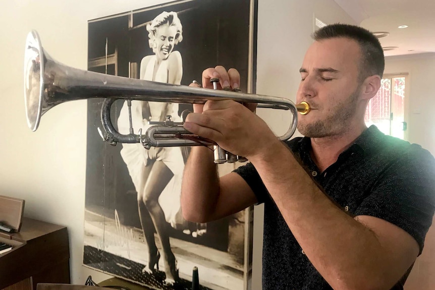A man blowing a trumpet.