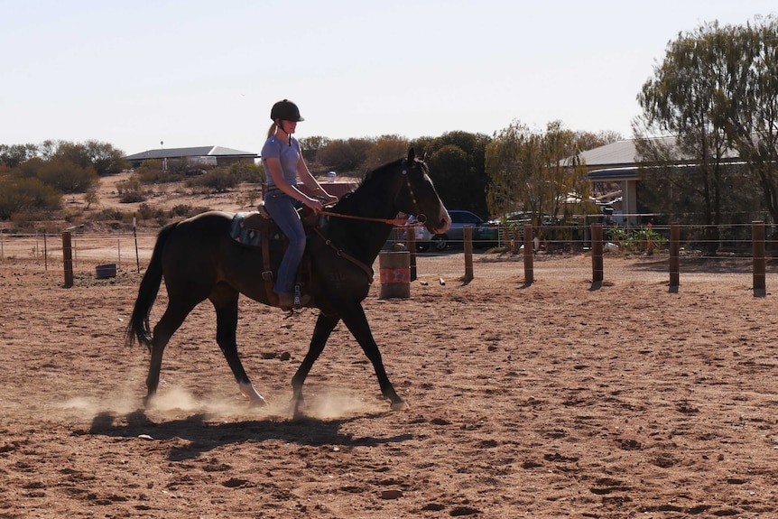 Gracie Norley riding her horse Sydney in the yard behind her home in Broken Hill