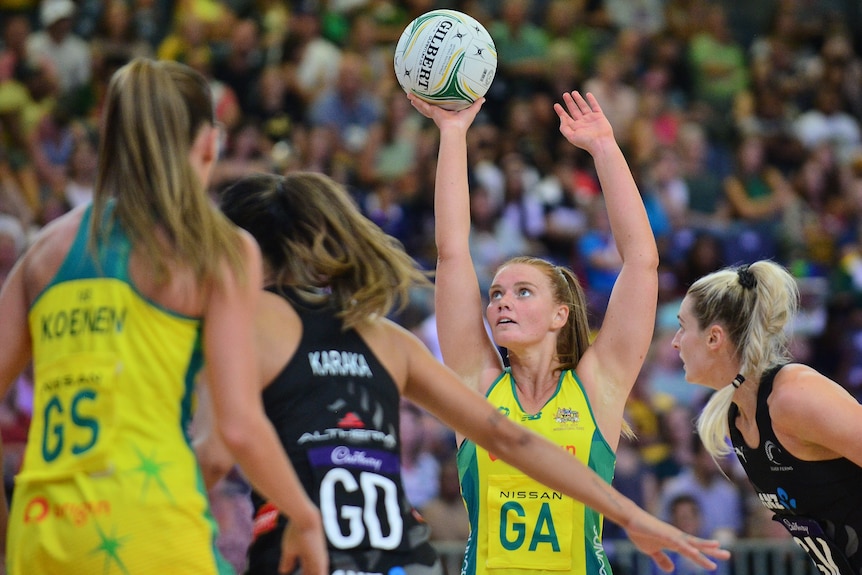 Steph Wood holds the ball in her right hand as she aims to shoot