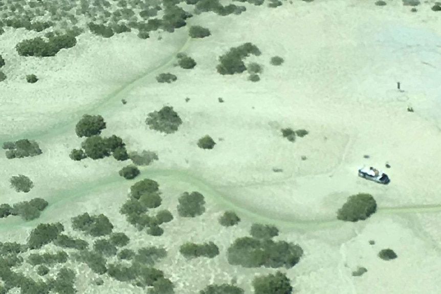 Aerial shot of car bogged in the Dampier Peninsula, showing scrubby bush.