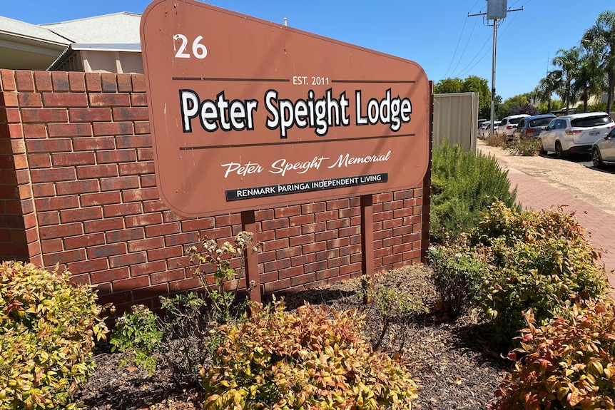 a brown sign nestled in a green garden reads Peter Speight Lodge, Renmark Paringa Independent Living 