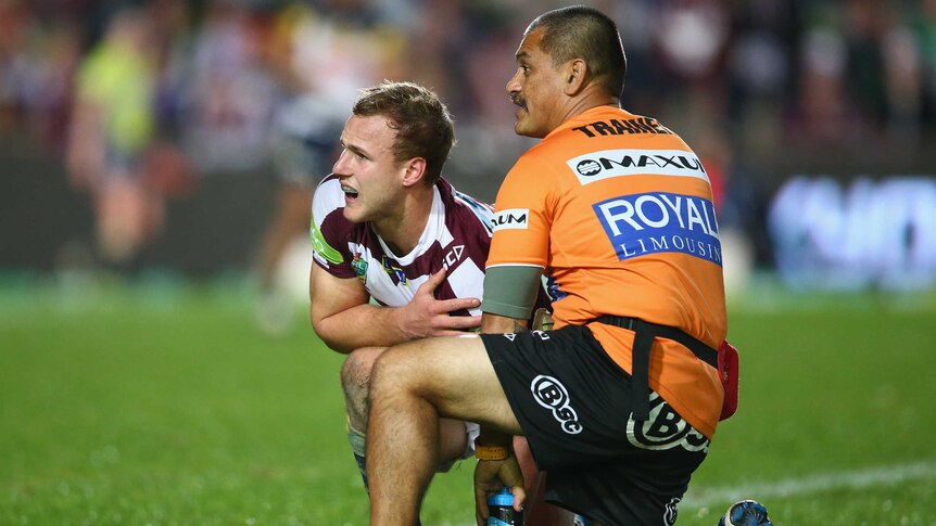 Injury blow ... Daly Cherry-Evans receives attention from a Sea Eagles trainer in the first half
