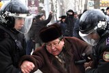 Police detain an opposition supporter in Almaty, Kazakhstan