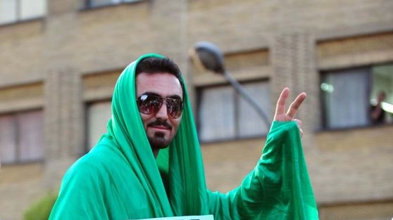 An opposition supporter shrouds himself in green, showing his allegiance to defeated candidate Mir Hossein Mousavi.