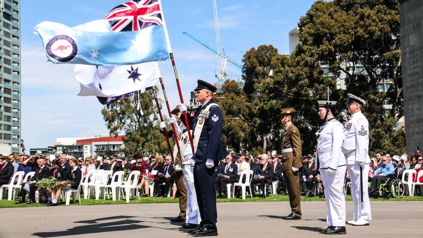 Flags for the three military services fly at Melbourne's Shrine of Remembrance.