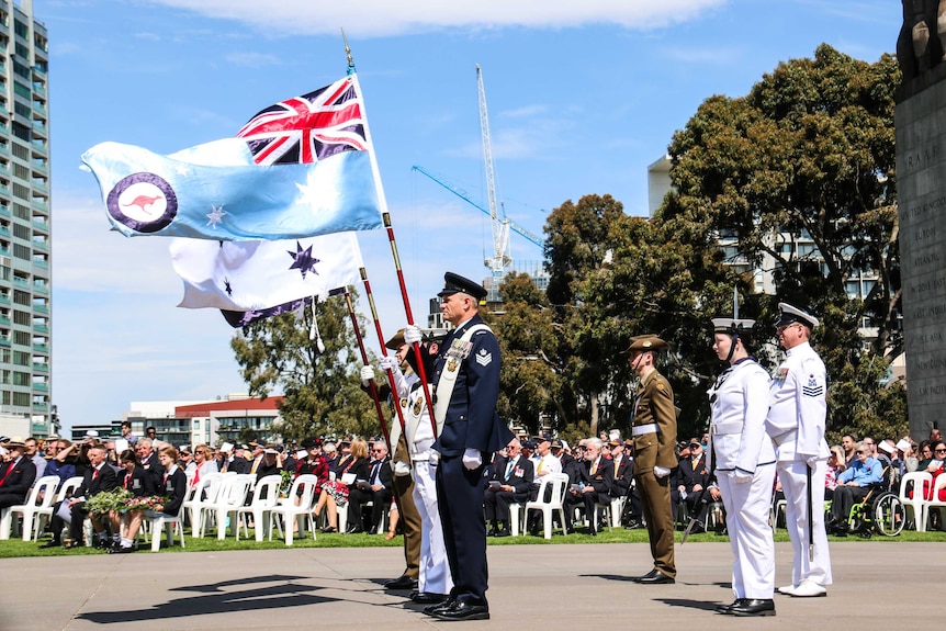 Flags for the three military services fly at Melbourne's Shrine of Remembrance.