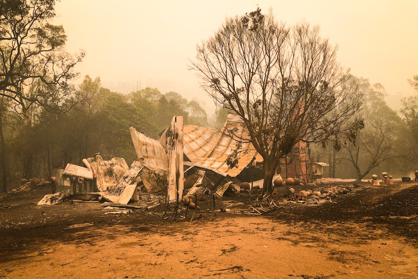 Remains of a timber and corrugated iron building after a bushfire.