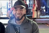 Twenty-year-old Johnson Kokozian wearing a cap looking at the camera and smiling
