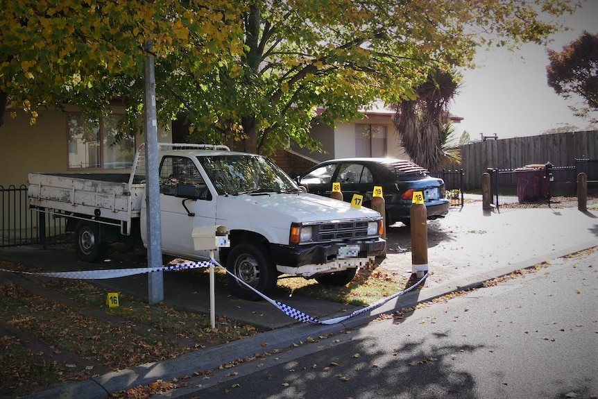 Yellow evidence markers at crime scene of shooting.