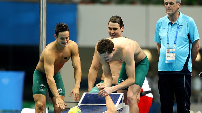 Team Australia congratulates Kenrick Monk after winning the men's 4x200m freestyle relay.
