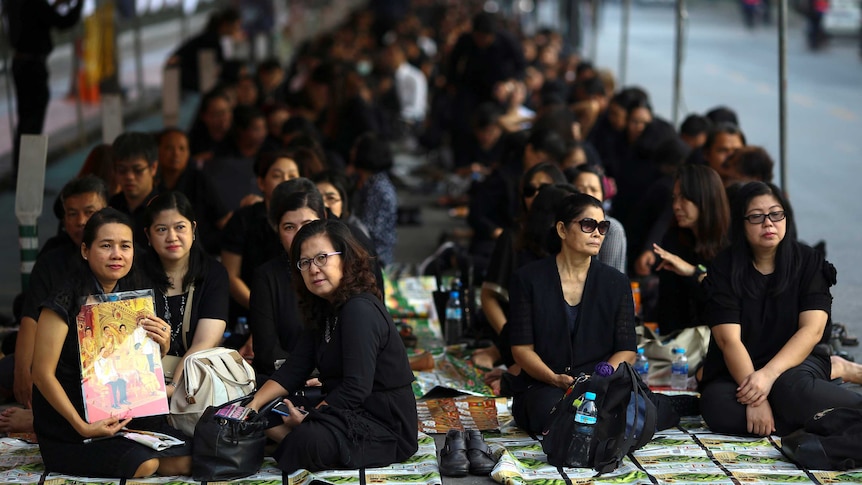 Mourners wait in line to offer condolences