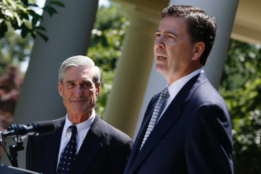 Robert Mueller looks at James Comey