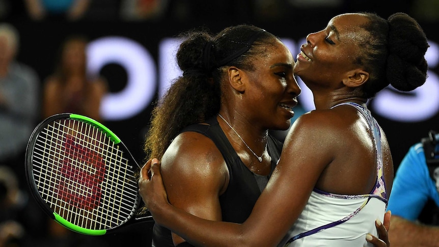 Serena Williams (L) and older sister Venus hug after the final last January.