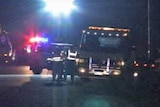 WA emergency vehicles, including tow truck, at night