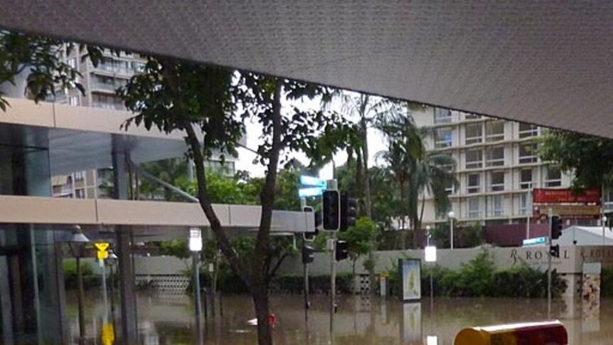 Floodwater creeps up a bench and post boxes in Brisbane's CBD on January 13, 2011.