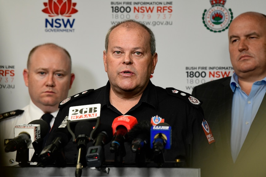 Three men sand in front of NSW media press conference 