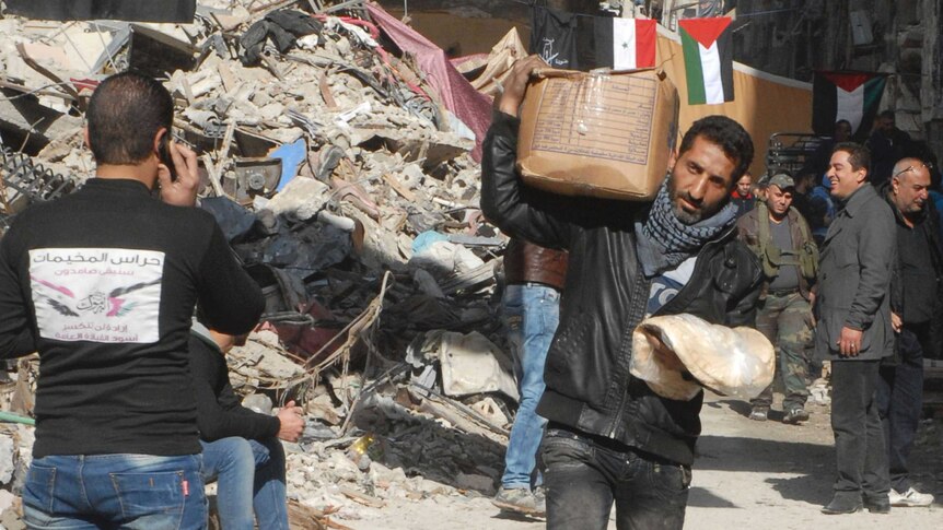Resident of Suria's Yarmouk camp receives aid