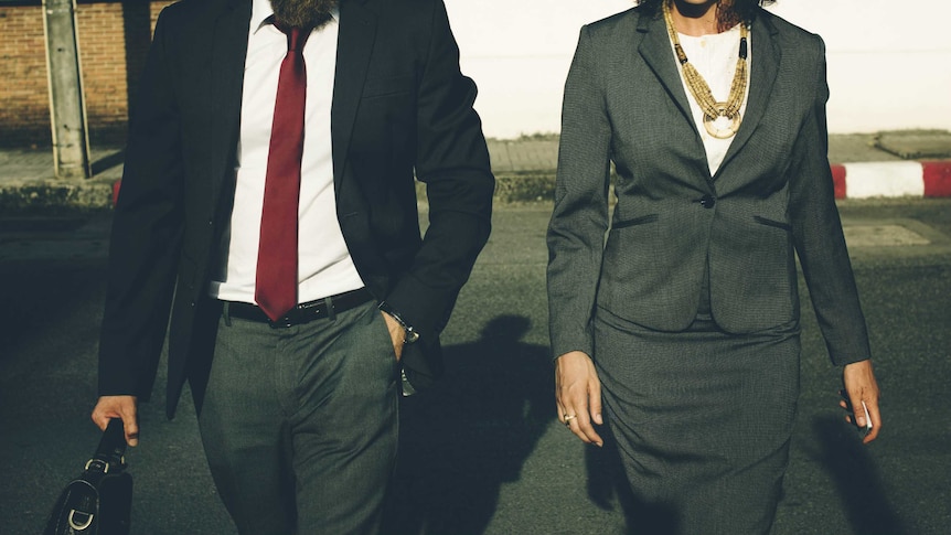 A man and a woman walk side by side.