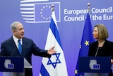 Benjamin Netanyahu and Federica Mogherini stand in front of a blue EU back drop.