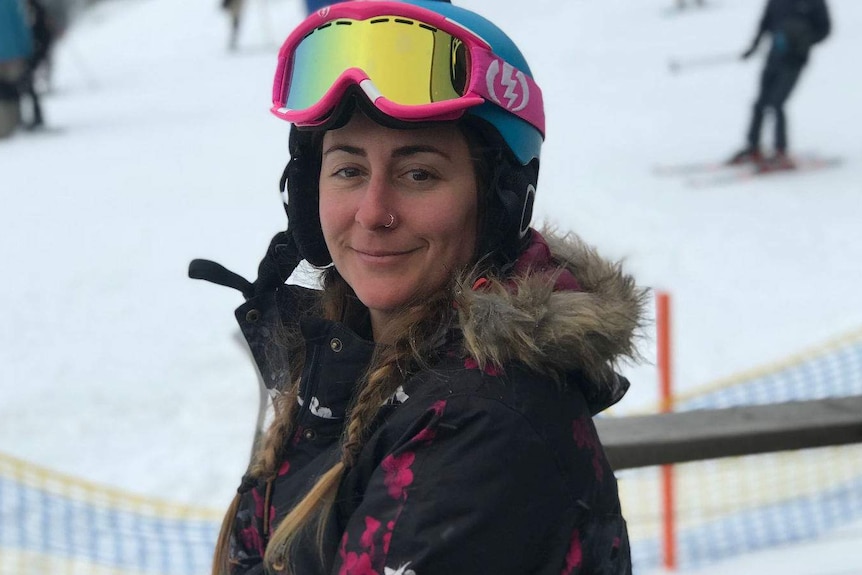 Tara Leach smiles at the camera in snow gear.