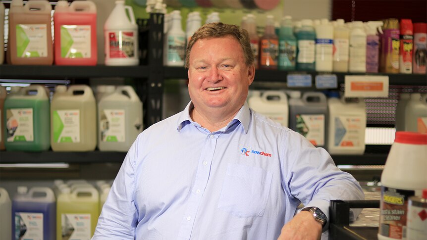 John Lamont stands in a small shop at his Nowchem business surrounded by cleaning products.