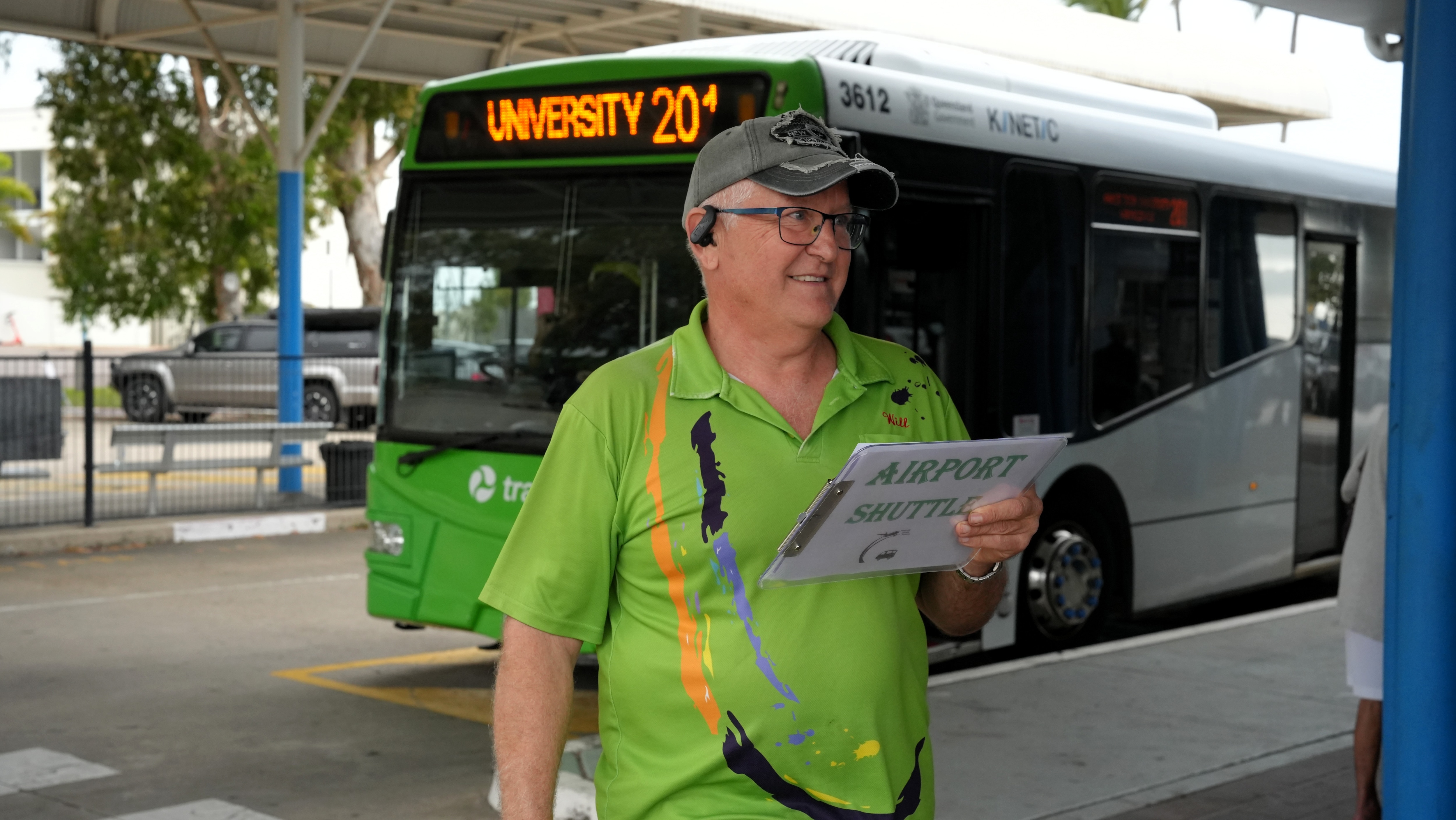 A middle-aged man in a bright green polo shirt.