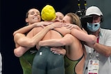 Australia's women's 4x200-meter freestyle relay team embrace outside of the pool at the Tokyo Games.