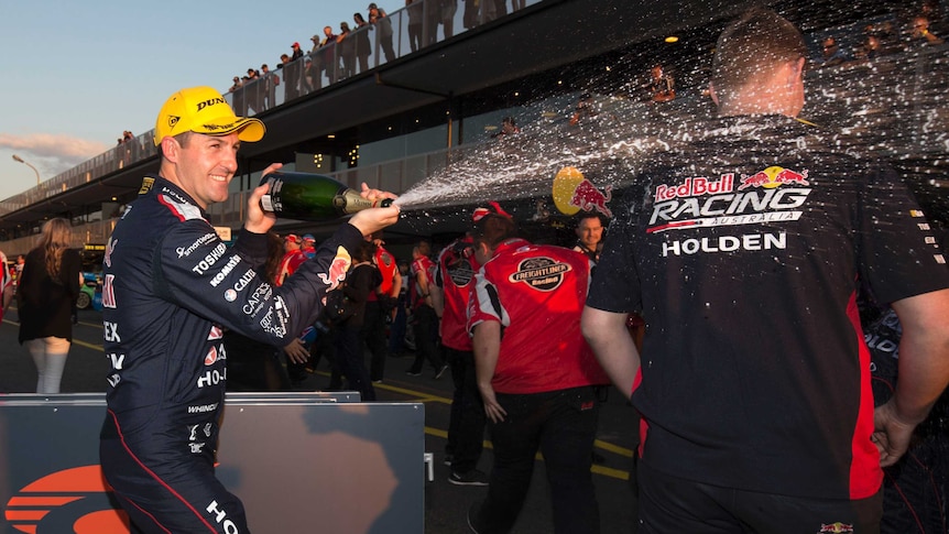 Jamie Whincup celebrates with champagne