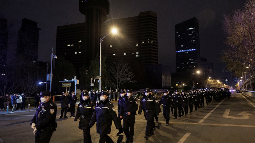 olice arrive at a protest against coronavirus disease (COVID-19) restrictions after a vigil.