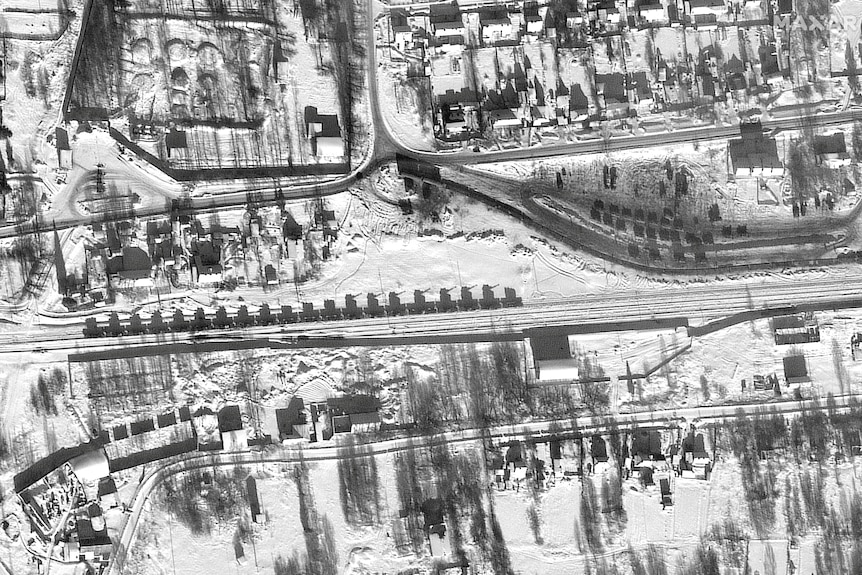 A satellite image shows armor and self-propelled artillery loaded in flatcars
