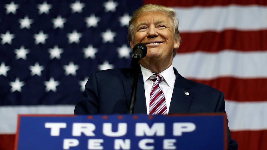 US Republican presidential nominee Donald Trump smiles at a rally