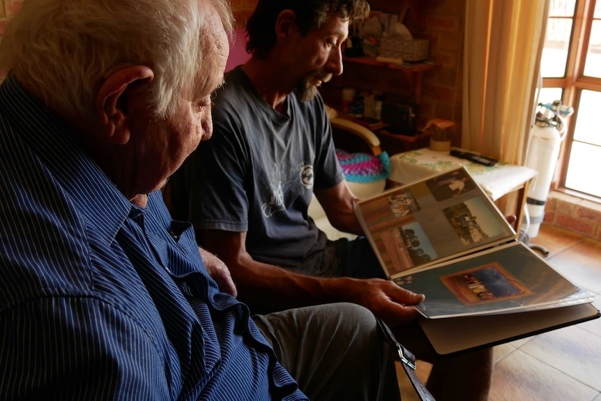 George and David Chadwick look through a family photo album