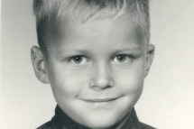 A black and white photo of a young boy with blond hair