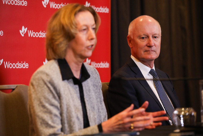 Meg O'Neill and Richard Goyder sitting and speaking to the media