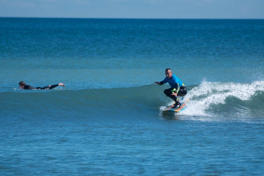 Neil Campbell surfs a small wave at Seaford.