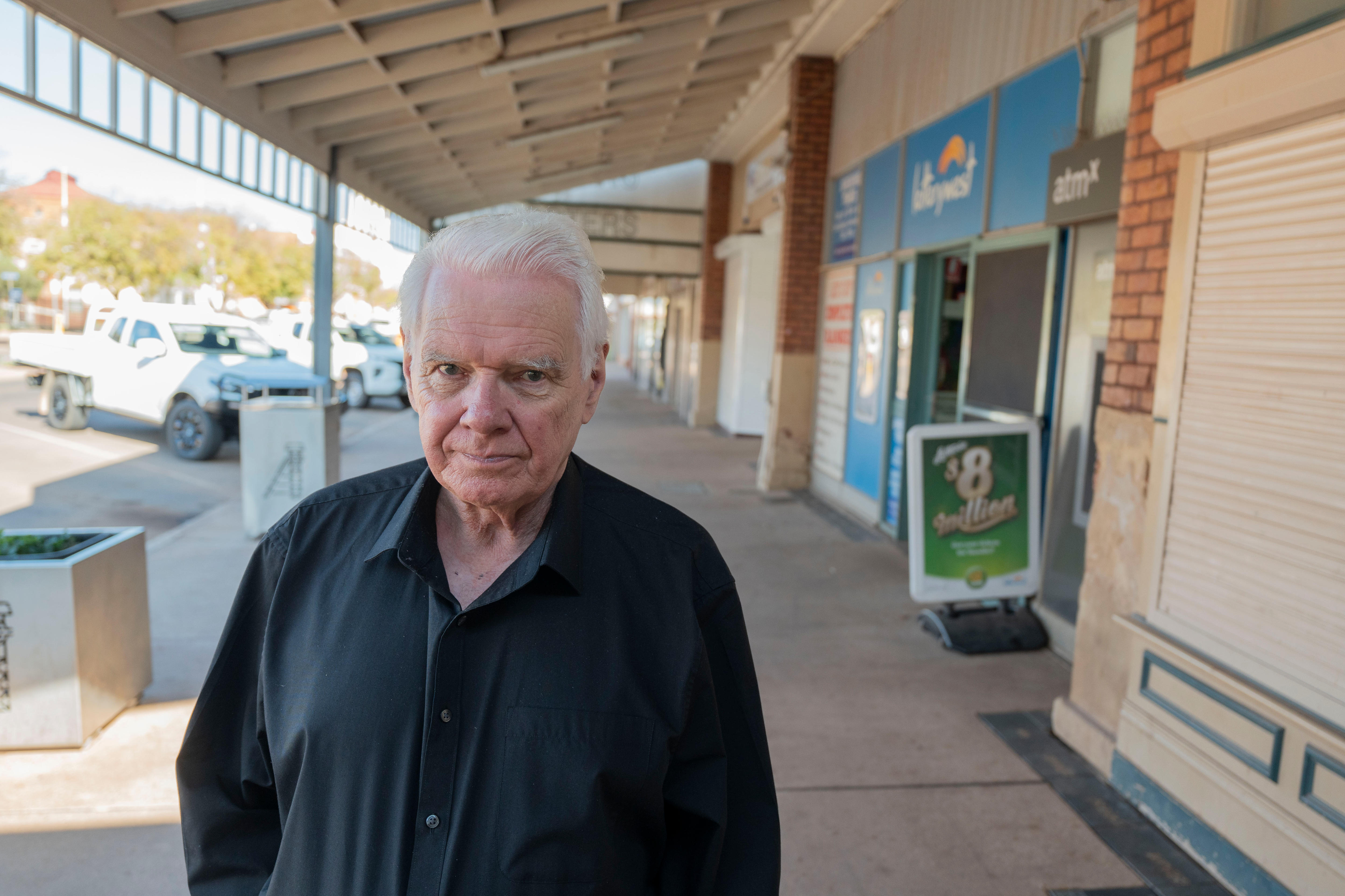 A photo of Boulder Newsagents owner Mike Saville outside his store