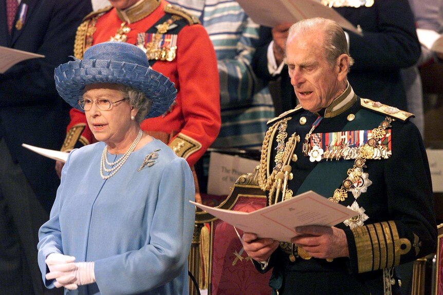 Britain's Queen Elizabeth II (L) and Prince Philip attend a service of Thanksgiving