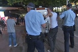 Police arrest a man in Canberra's city centre.