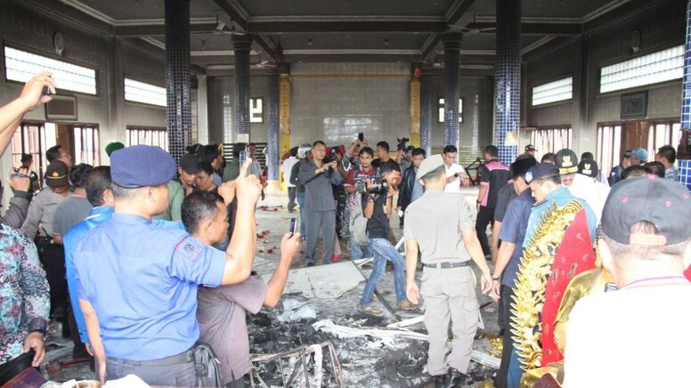 Police investigates the remains destruction caused by riots towards Buddhist temples in Medan