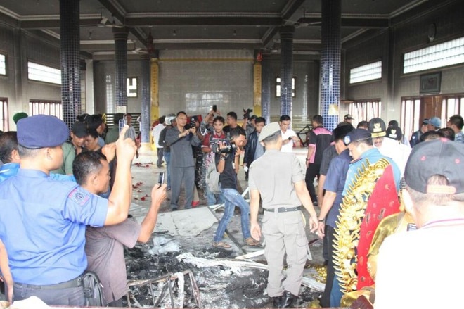 Police investigates the remains destruction caused by riots towards Buddhist temples in Medan