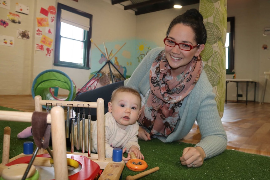 Louise takes time away from her desk to visit 7-month-old Hazel in the upstairs crèche.
