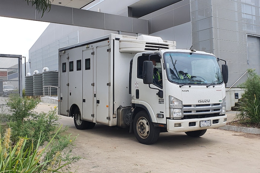 A large truck drives through a gate