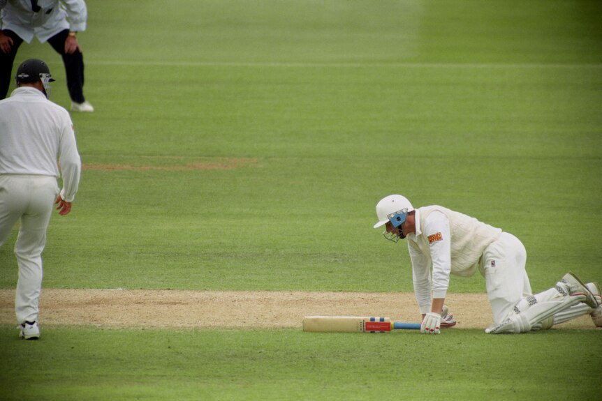 An Australian fielder stands over England batter Mike Atherton on his knees after being run out for 99 in a 1993 Ashes Test.