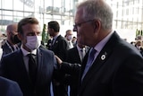 Prime Minister Scott Morrison puts his hand on French President Emmanuel Macron's shoulder at the COP26 summit.