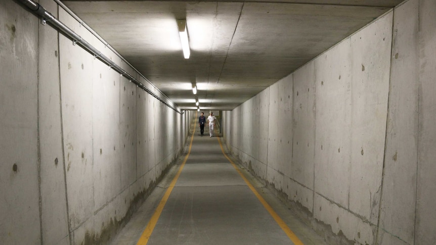 Walking in the concrete pedestrian tunnel at the Department of Defence.