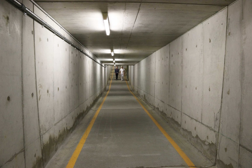 Walking in the concrete pedestrian tunnel at the Department of Defence.