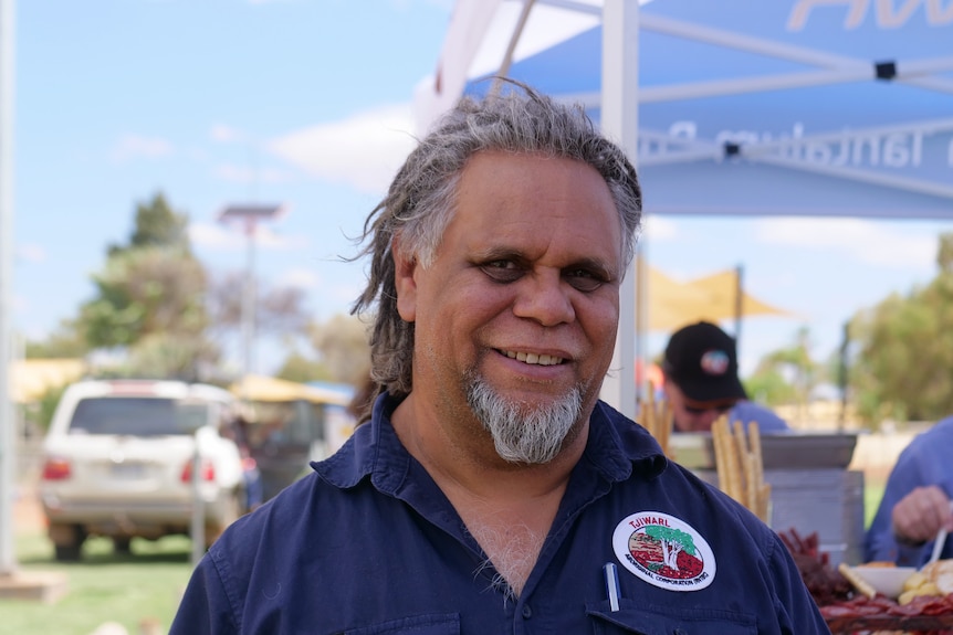 Kado Muir infront of a tent looking at the camera