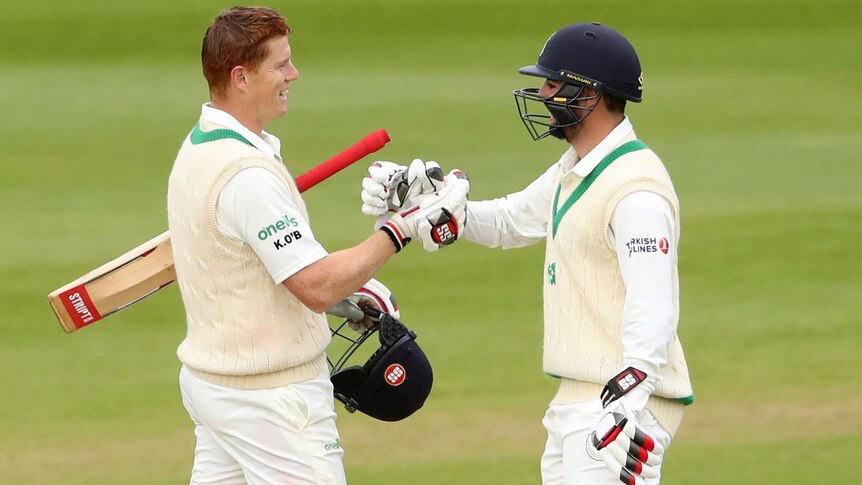 Ireland's Tyrone Kane (R), congratulates teammate Kevin O'Brien on a Test Century against Pakistan.