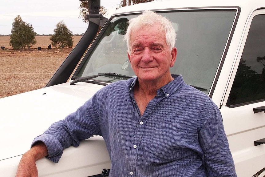 John Lush leans on his car