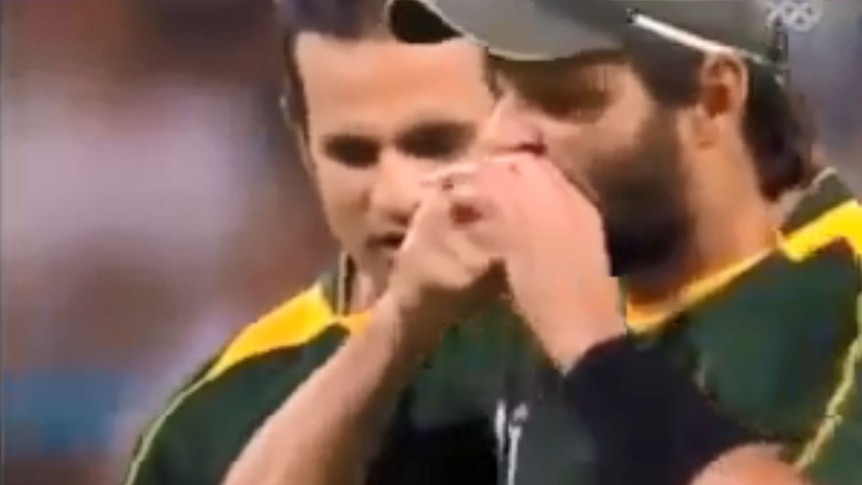 Pakistan star Shahid Afridi can be seen biting the ball.